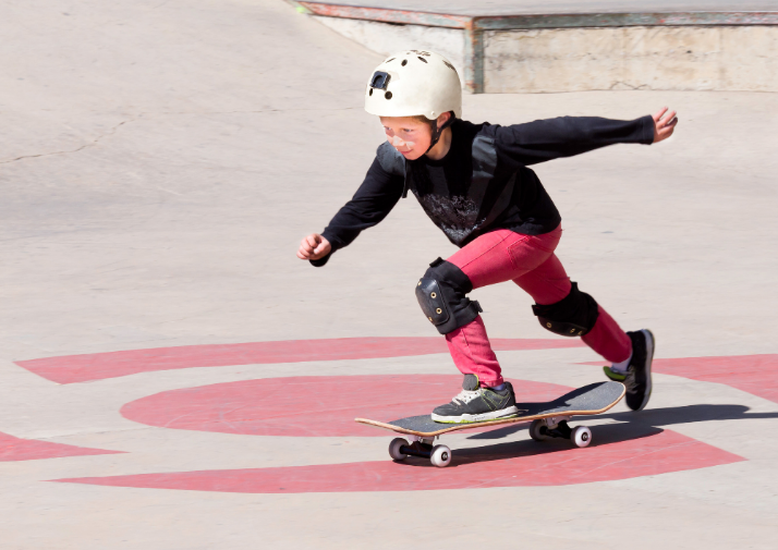 A person skateboarding with a helmet on for the prevention of spinal cord injury